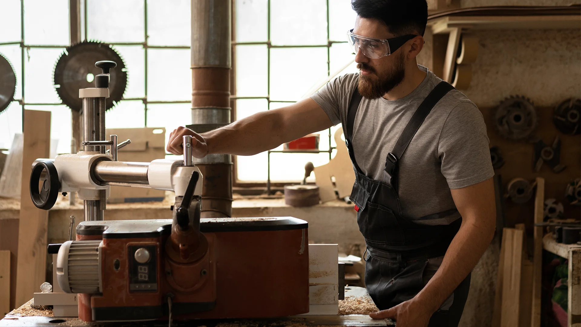 Carpenter cutting mdf board inside workshop