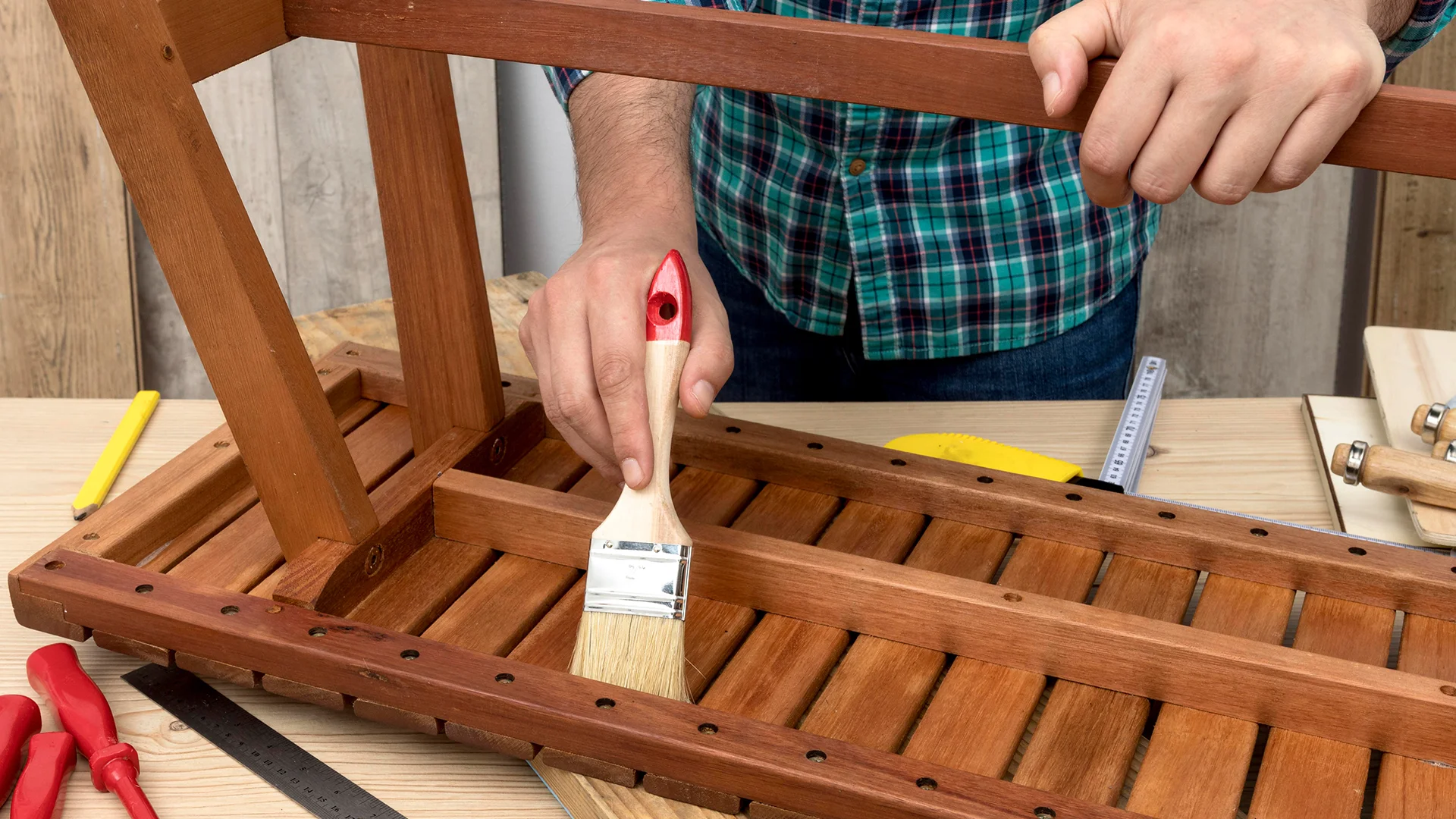 Skilled carpenter worker using his tools on wood
